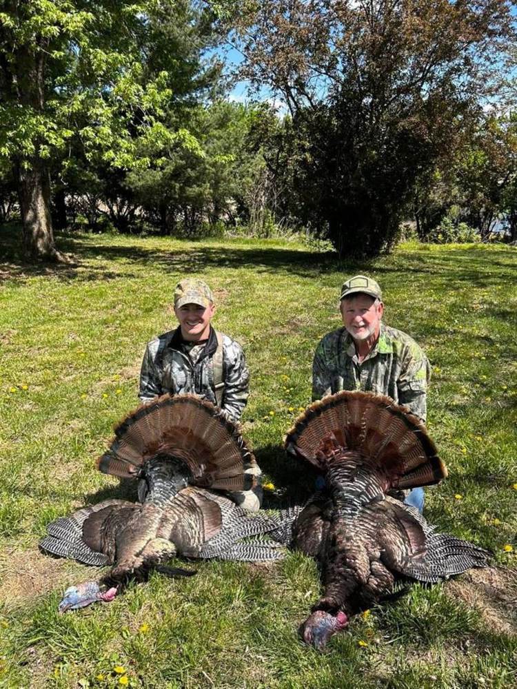 Hunters with two Missouri turkeys